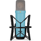 Rode NT1 Signature Series condenser microphone with black body and gold accents, positioned on a stand for studio recording.