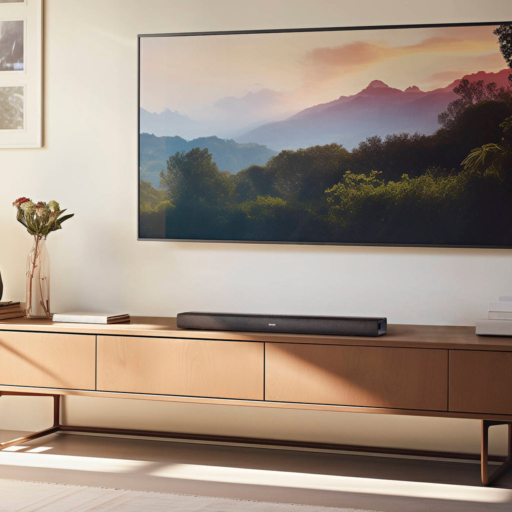 Denon DHT-S218 soundbar with sleek black design, featuring multiple speaker drivers and a compact, modern look for home theater.