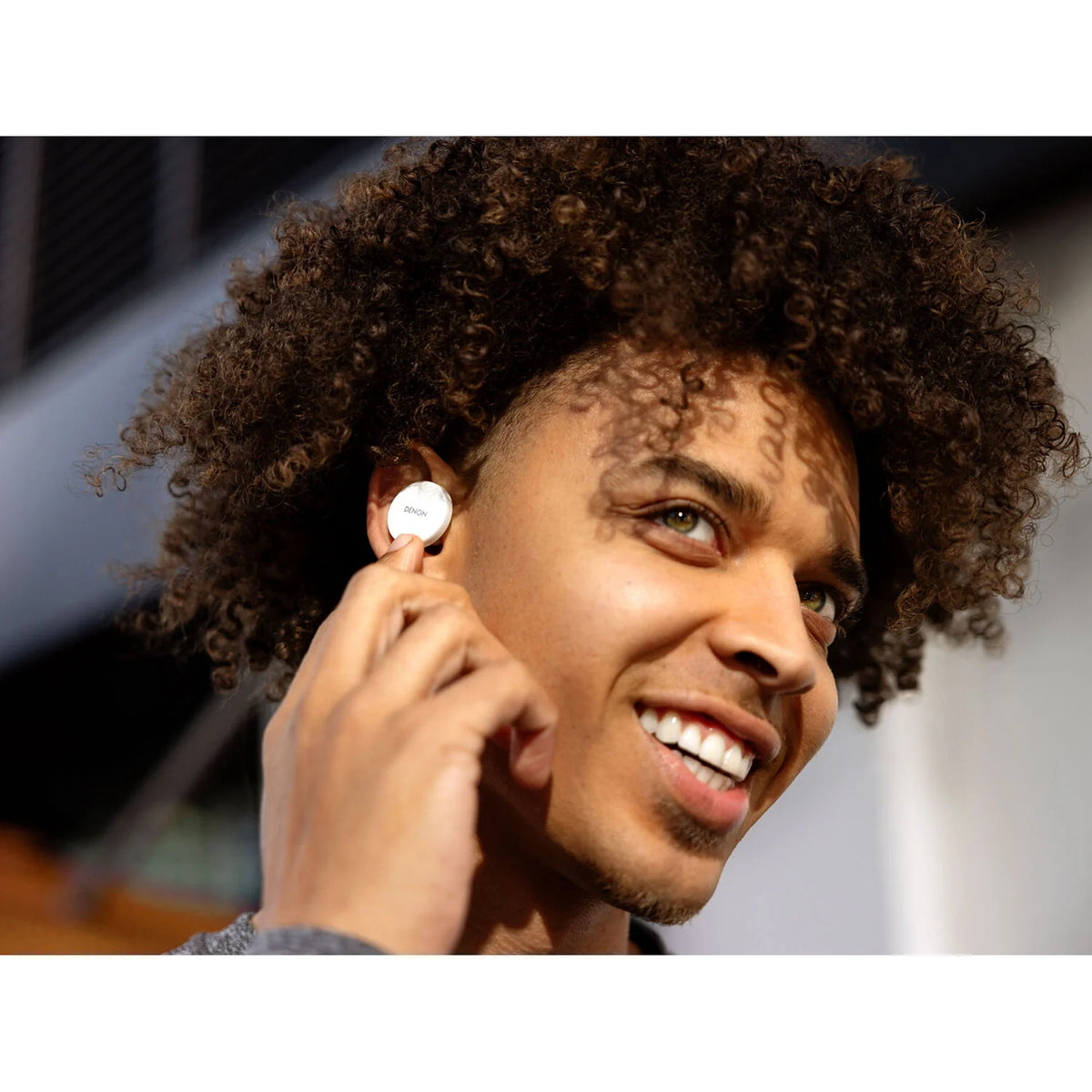 Denon PerL wireless in-ear headphones shown with sleek black design and in-ear earbuds for premium sound comfort.