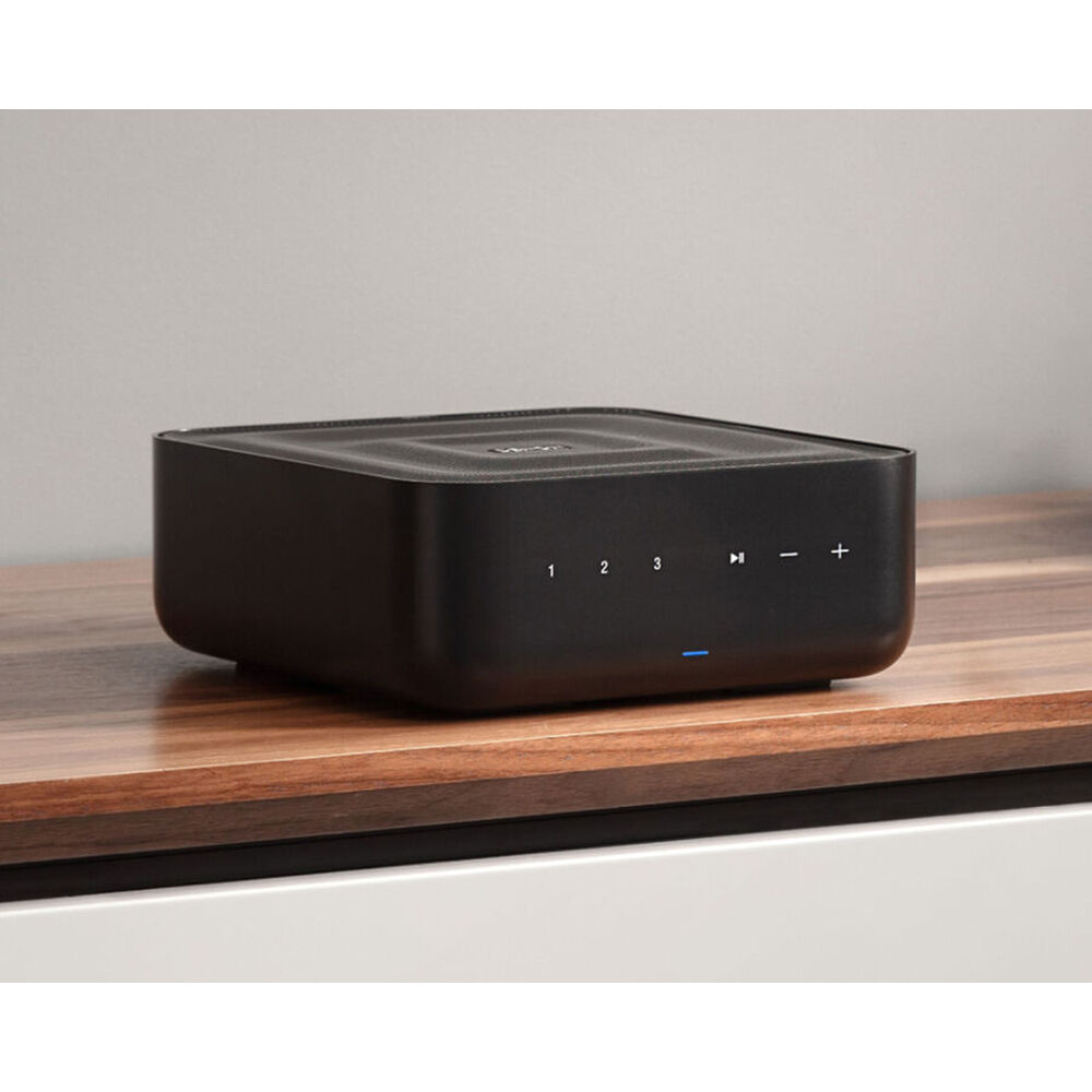 Denon Home Amp stereo amplifier with sleek black design, multiple input ports, and control knobs on the front panel.