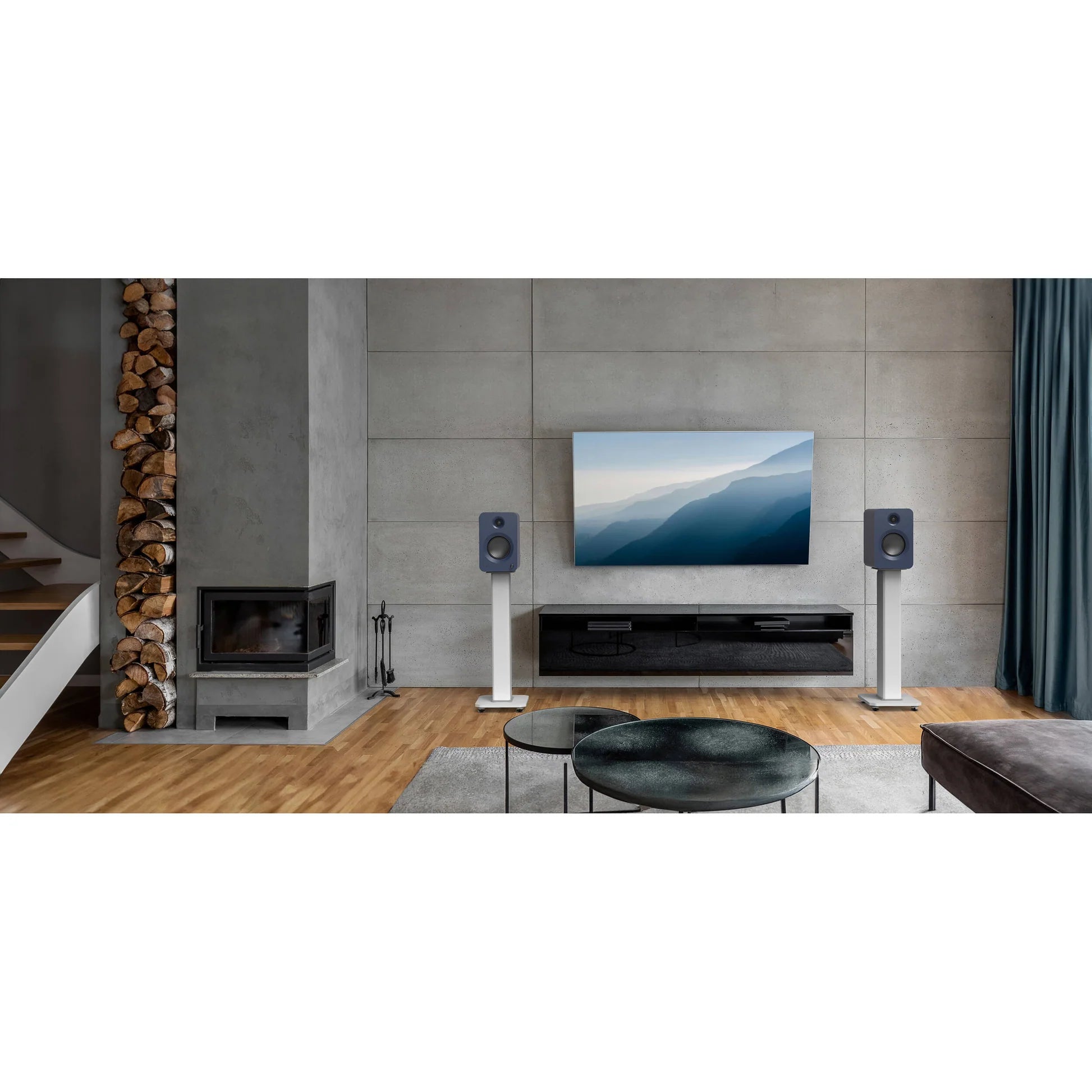 Kanto Audio Ren active bookshelf speakers with sleek black finish showing the front grille and control knobs.