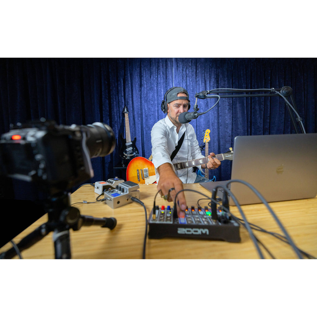 Zoom LiveTrak L-6 digital mixer with multiple input channels, control knobs, and digital display for professional audio mixing.