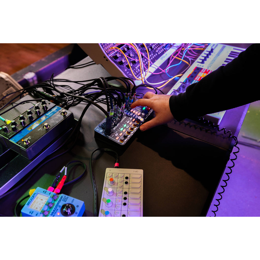 Zoom LiveTrak L-6 digital mixer with multiple input channels, knobs, and display screen for professional audio mixing.