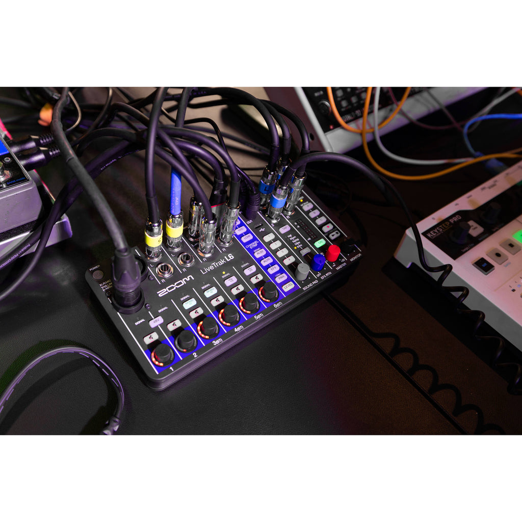 Zoom LiveTrak L-6 digital mixer with multiple input channels, knobs, and display screen for professional audio mixing.