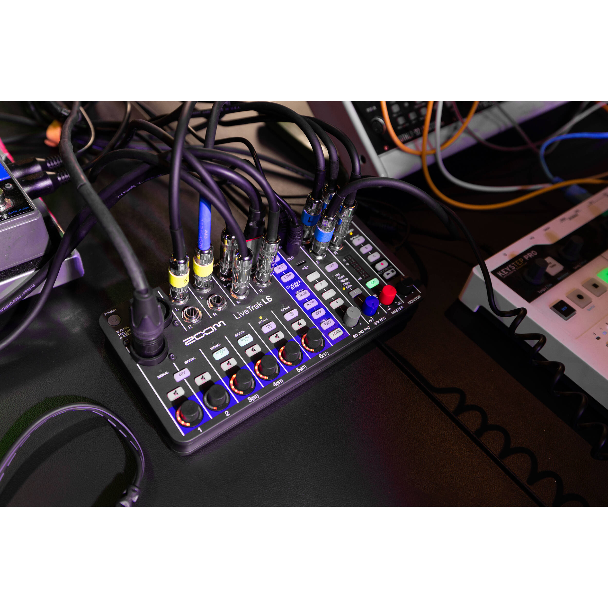 Zoom LiveTrak L-6 digital mixer with multiple input channels, knobs, and display screen for professional audio mixing.