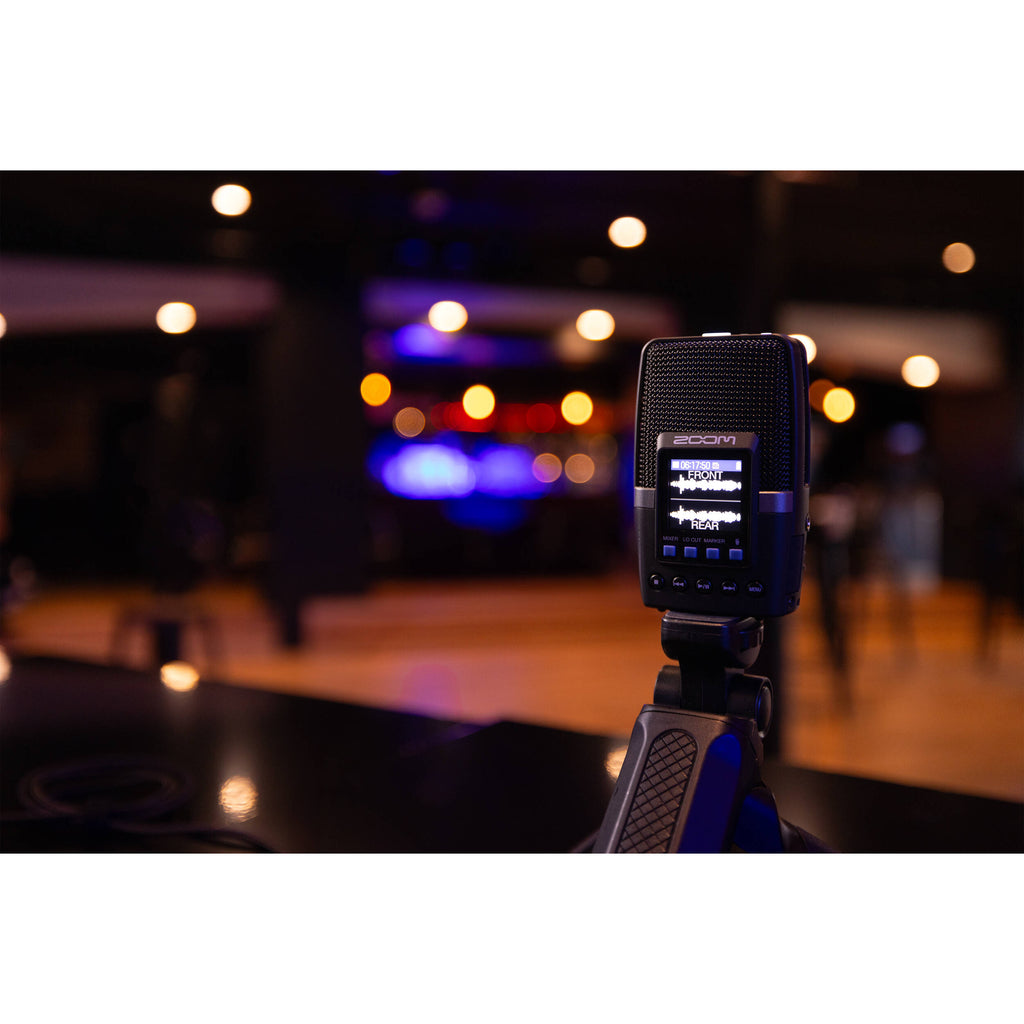 Zoom H2essential digital recorder with multiple microphones, control buttons, and a compact design for high-quality audio recording.
