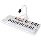 Arturia MiniFreak synthesizer with vocoder feature, compact electronic music instrument with various knobs and controls.