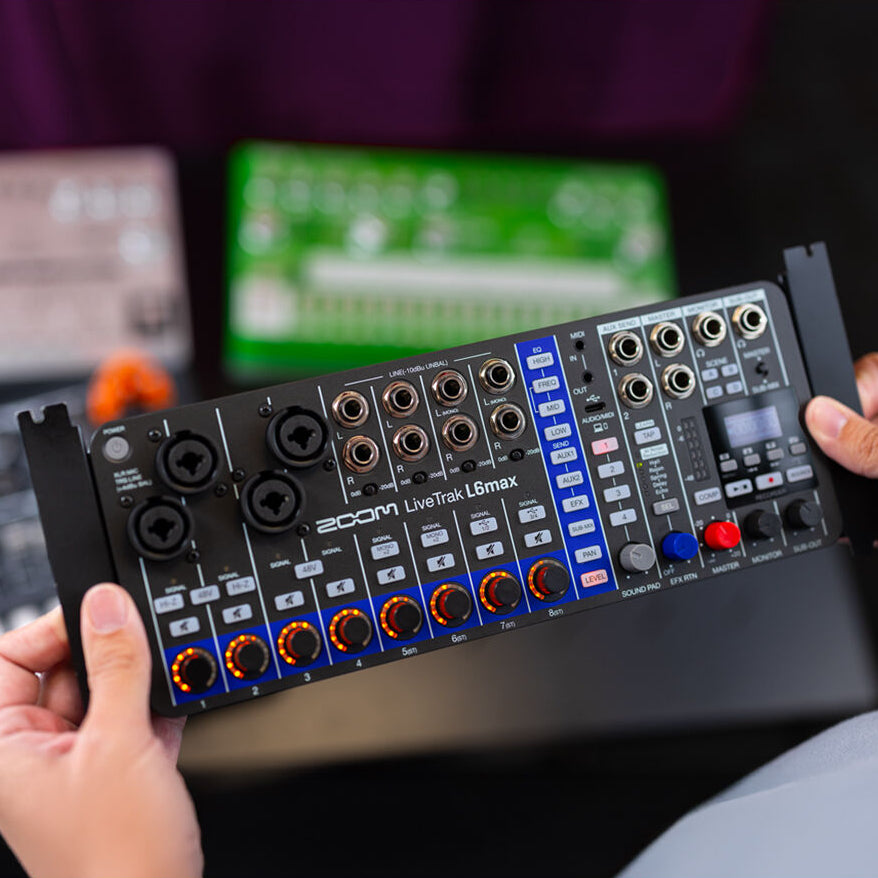 Zoom LiveTrak L6max digital mixer with multiple input channels and control knobs, designed for professional audio mixing.