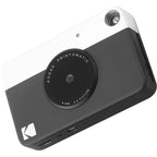 Kodak Printomatic instant compact camera with black body and lens, ready for quick photo prints.