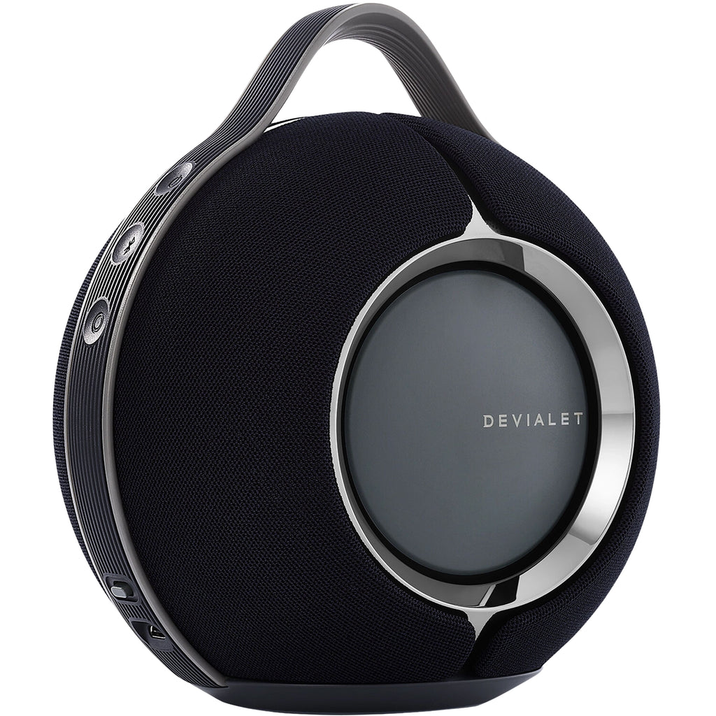 Devialet Mania portable speaker showing sleek design, control buttons, and fabric grille in a modern setting.
