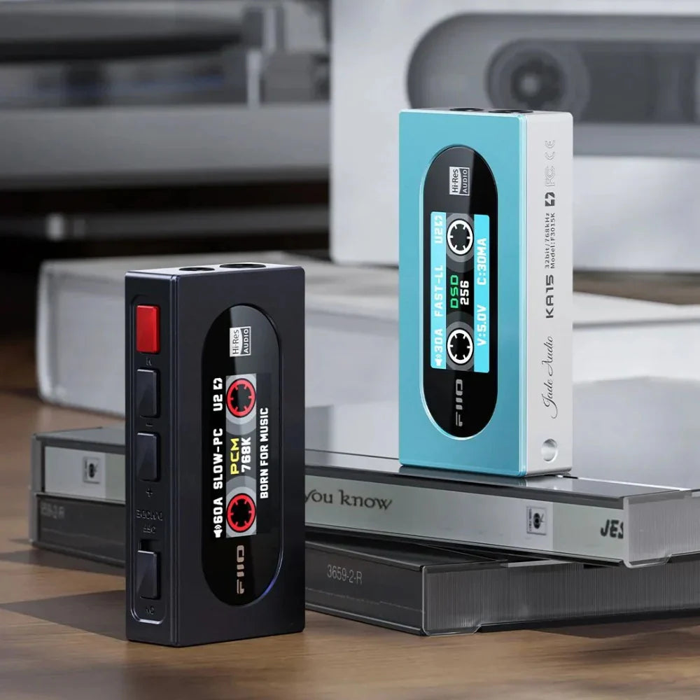 FiiO KA15 headphone amplifier and DAC with silver finish, compact design, and multiple input ports for high-quality audio.