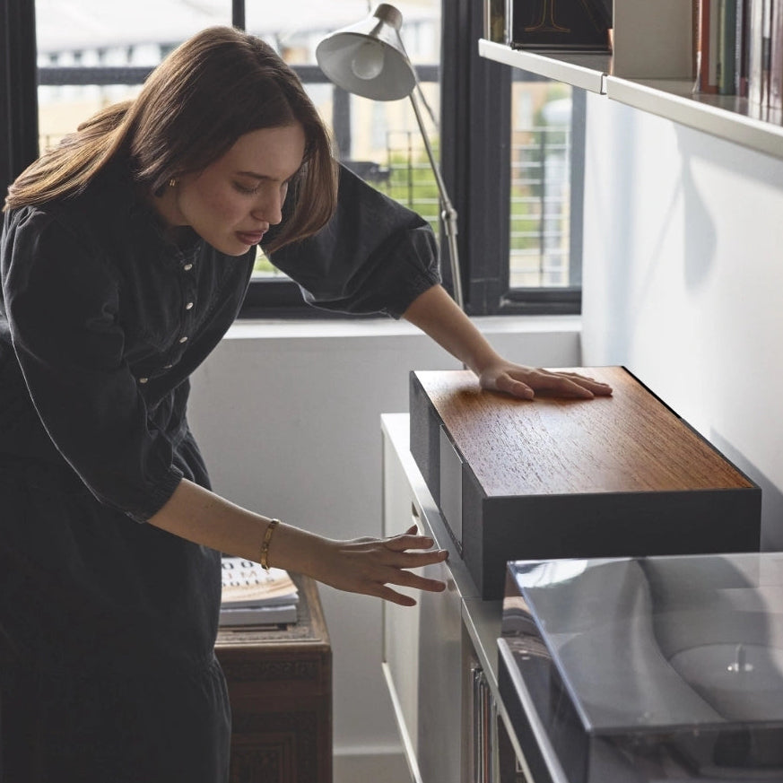 Cambridge Audio Evo One wireless speaker shown on a home shelf, designed for high-quality music and audio playback.