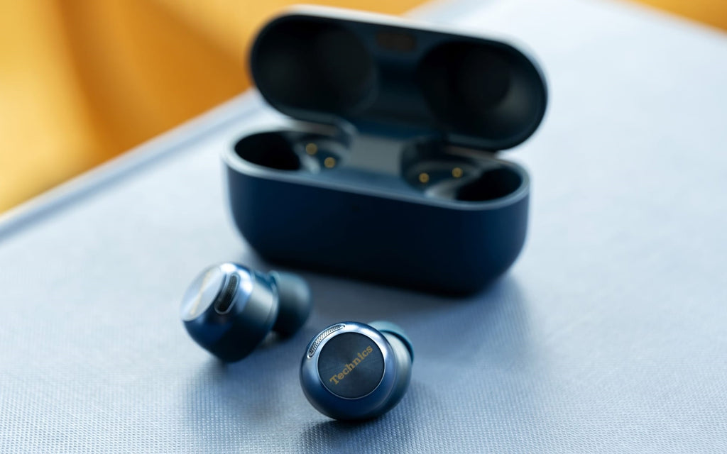 Technics EAH-AZ100 wireless in-ear headphones in midnight blue, with sleek earbuds and compact charging case.