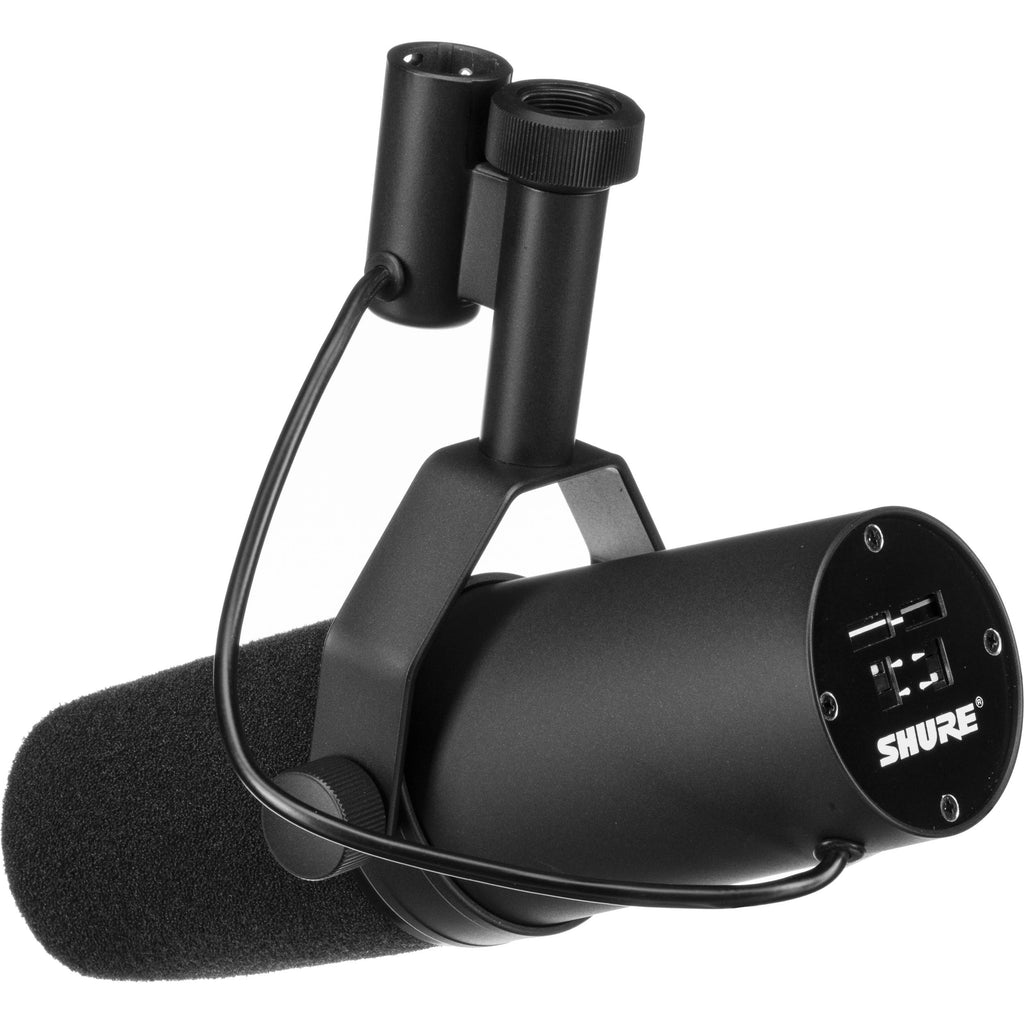 Shure SM7B dynamic microphone with MVX2U XLR-to-USB adapter bundle on a desk setup with a pop filter and audio equipment.