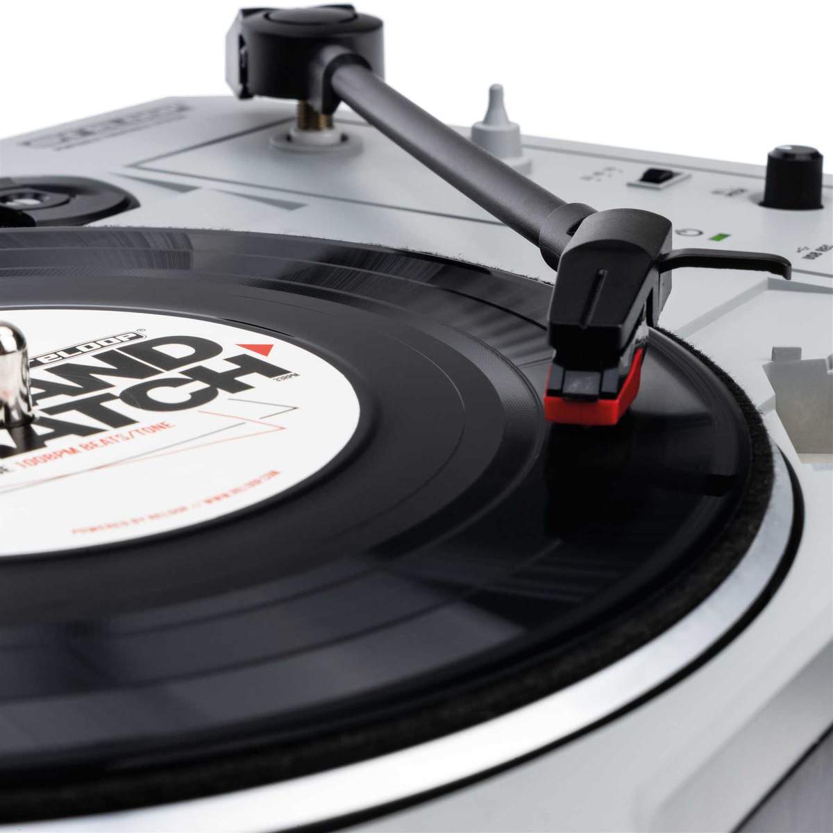 Reloop Spin turntable cartridge installed on a DJ turntable, close-up view of stylus and cartridge components.
