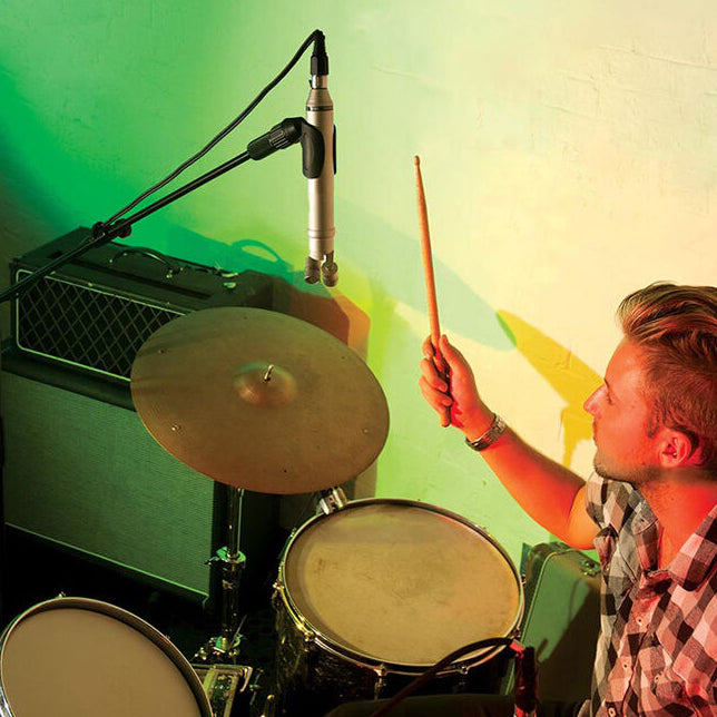 Rode NT4 condenser microphone with dual capsules and professional audio capture, shown with microphone stand and audio cable.