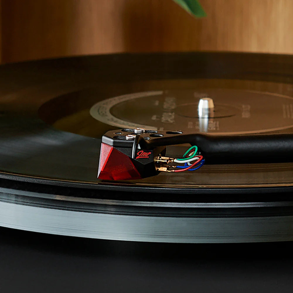 Close-up of Ortofon 2M Red stylus for turntables, showing the detailed needle and cartridge connection.