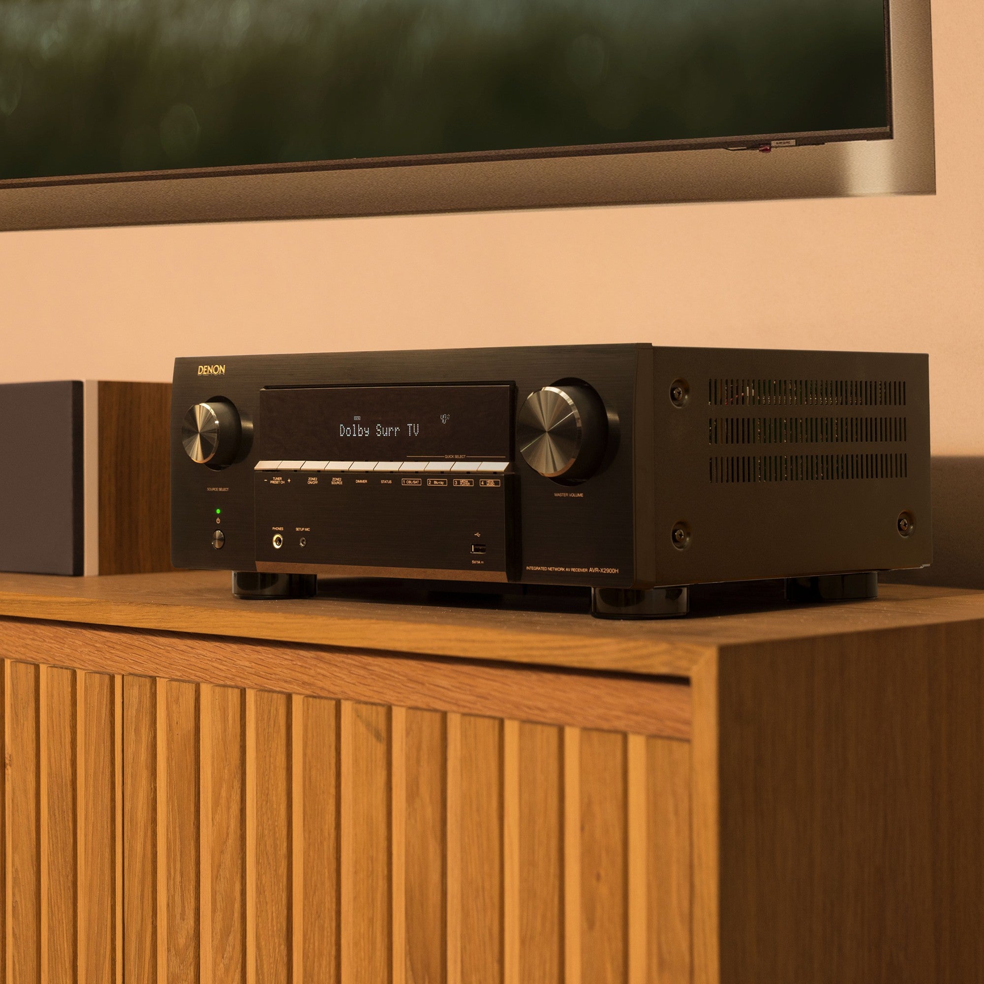 Denon AVR-X2900H DAB stereo amplifier with multiple input ports and digital display, showcasing its modern design.