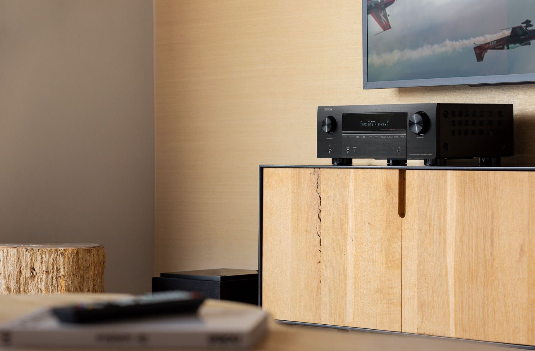 Denon AVC-X3800H stereo amplifier with multiple input ports and sleek black design, showcasing front panel controls and display.