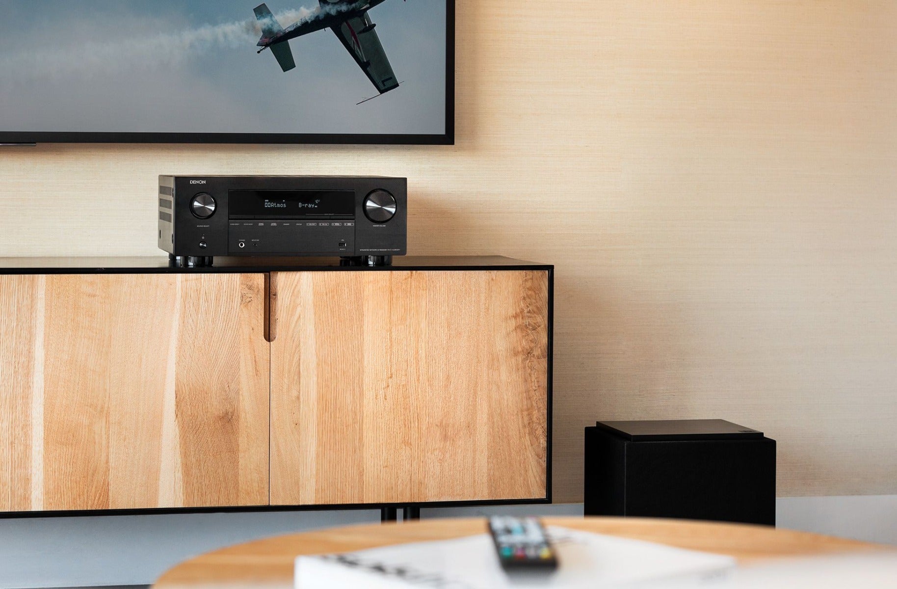 Denon AVC-X3800H stereo amplifier with front control panel, set on a white background, showcasing its sleek design.