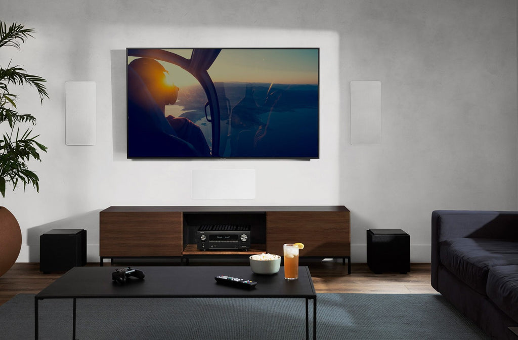 Denon AVC-X3800H stereo amplifier with multiple input ports and control knobs on a black metal chassis.