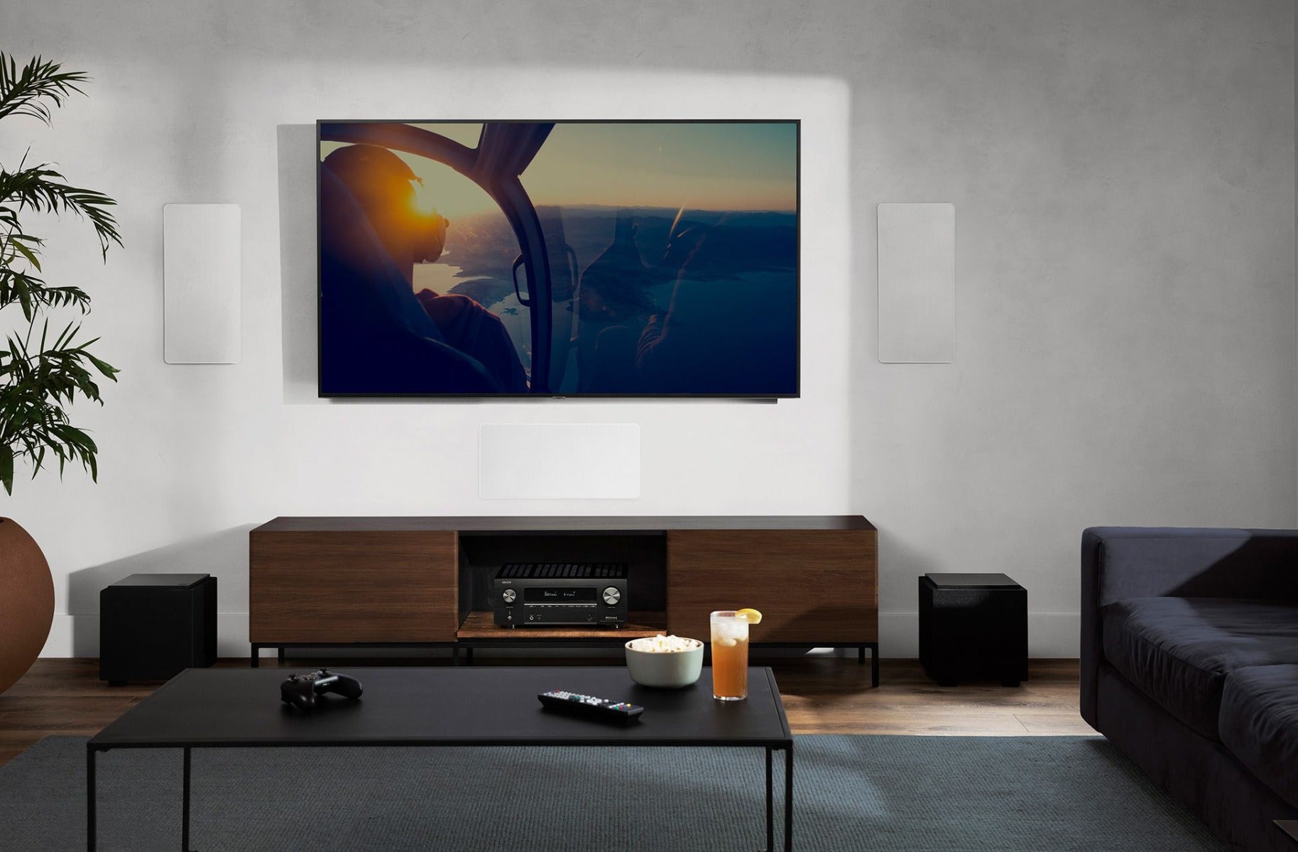 Denon AVC-X3800H stereo amplifier with multiple input ports and control knobs on a black metal chassis.