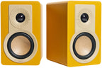 DALI Kupid passive bookshelf speakers with black finish and sleek design, showing the front speaker grille and wood grain sides.