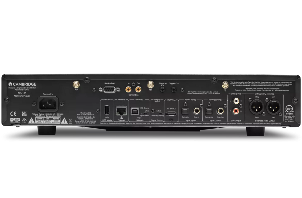Cambridge Audio EXN100 music streamer showing front panel with display and control buttons, connected to audio equipment.