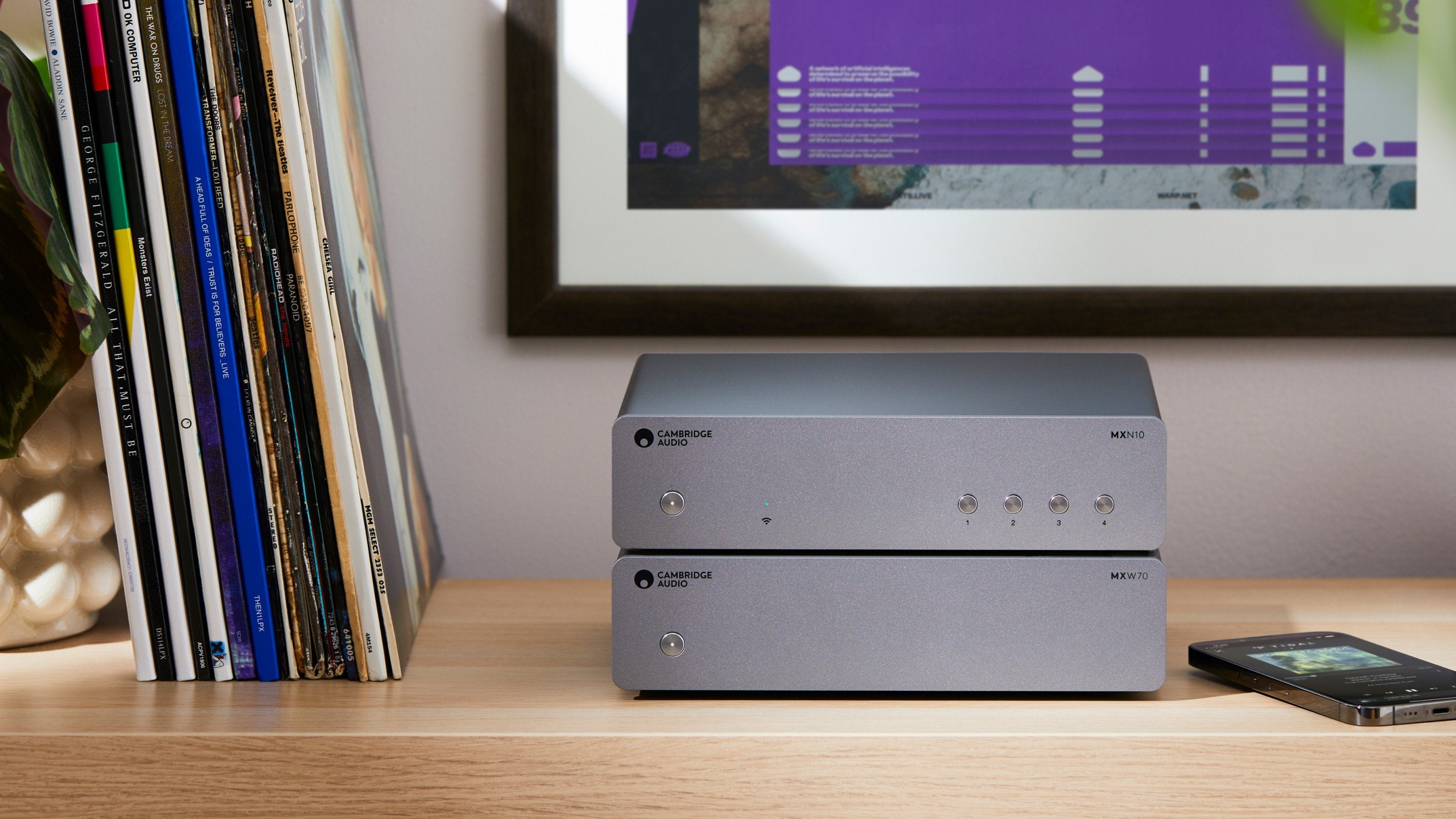 Cambridge Audio MXW70 stereo amplifier with sleek black design and control knobs, showcasing high-quality audio equipment.