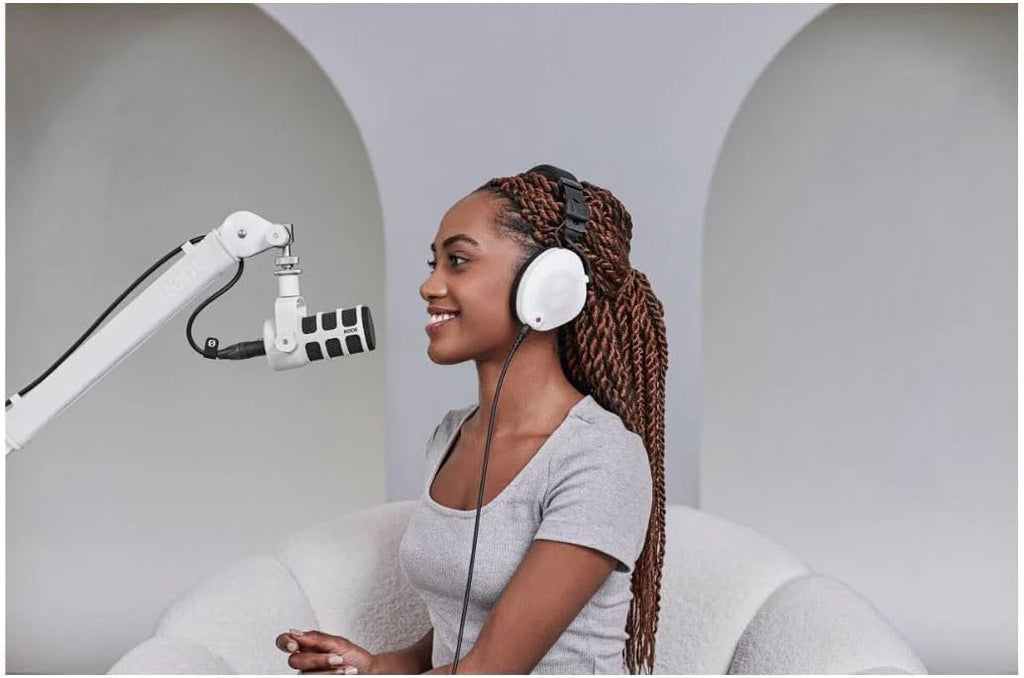 Rode PodMic dynamic microphone with metal build and mounted on a stand, ideal for podcasting and broadcasting.
