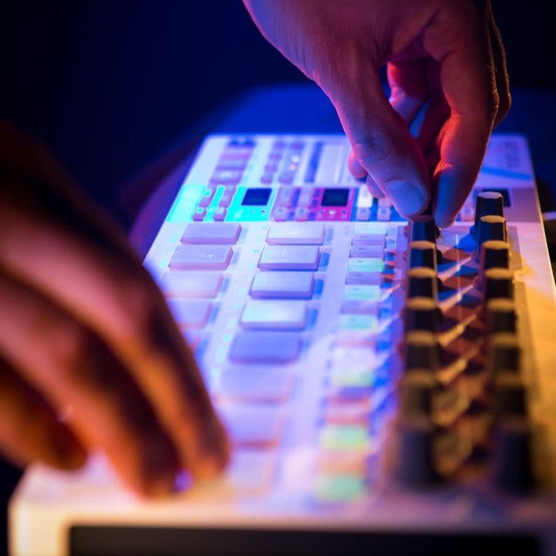 Arturia BeatStep Pro sequencer with multiple pads and control knobs, used for music production and live performance.
