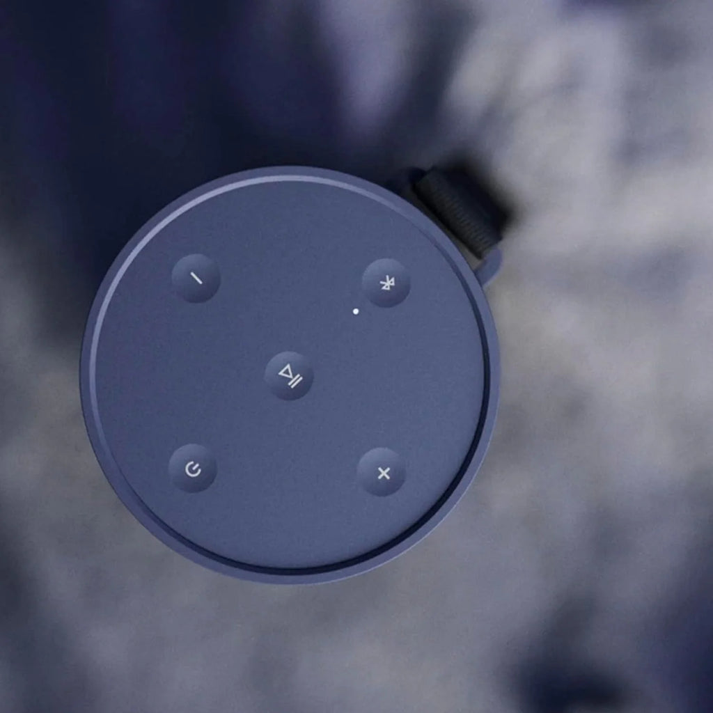 Bang & Olufsen Beosound Explore portable speaker in black, showing its rugged design with control buttons and textured surface.