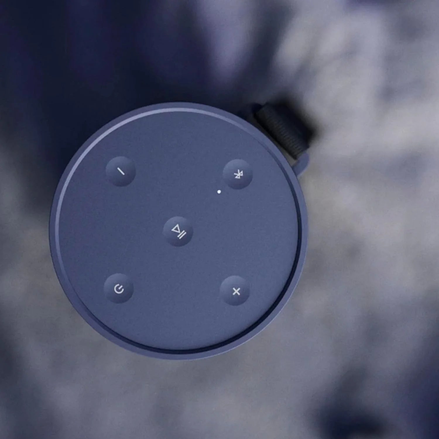 Bang & Olufsen Beosound Explore portable speaker in black, showing its rugged design with control buttons and textured surface.
