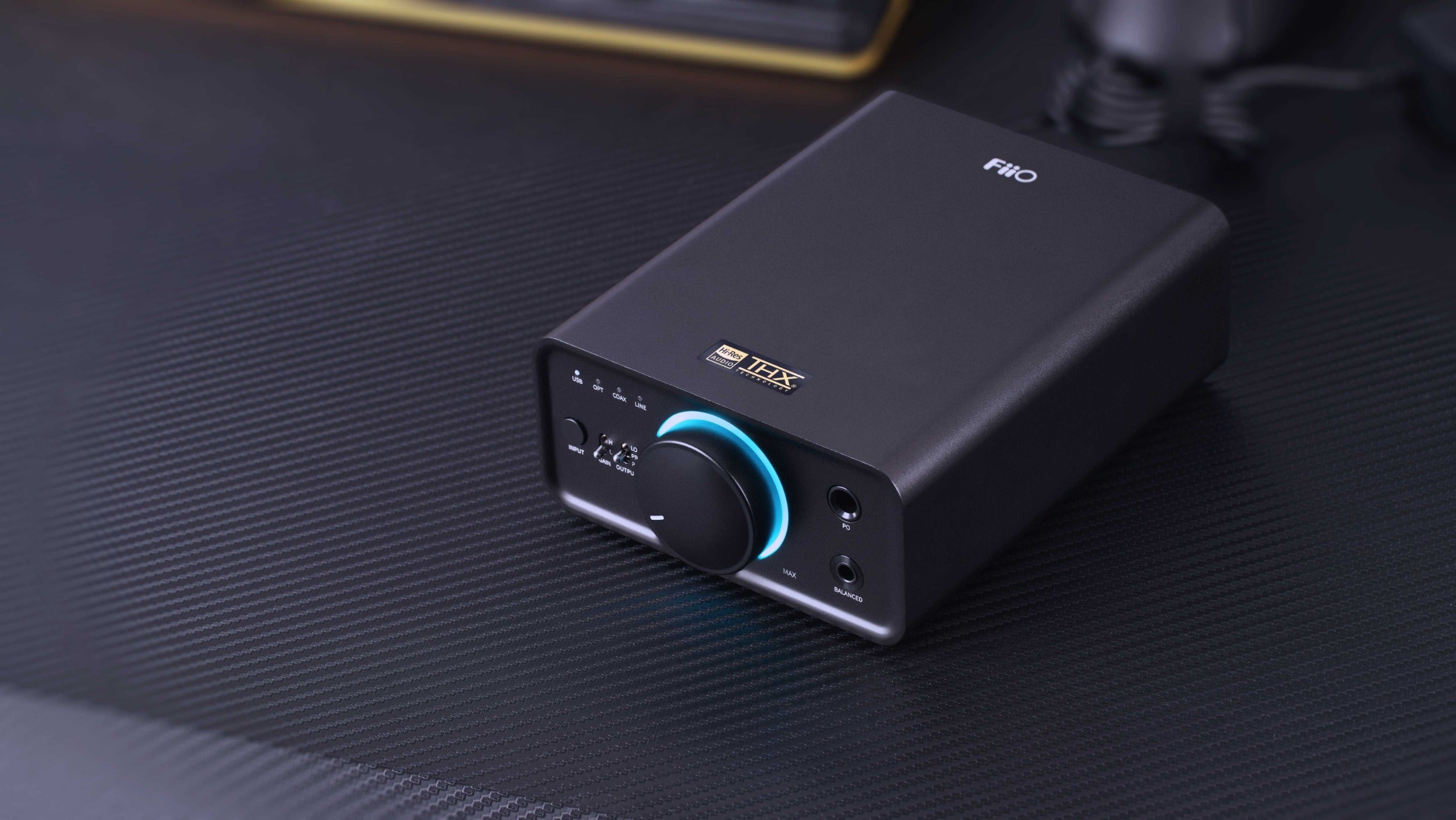 FiiO K7 BT headphone amplifier and DAC with sleek black design and multiple input ports for high-quality audio.