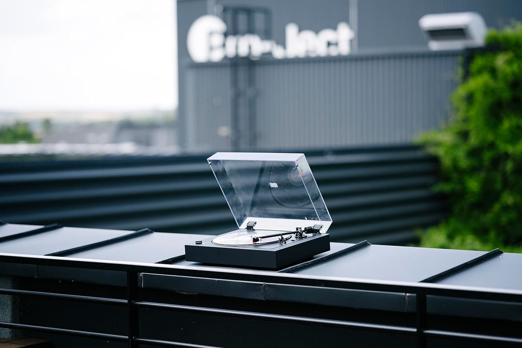 Pro-Ject Automat A2 turntable with 2M Red cartridge, featuring a sleek black base and tonearm for high-quality vinyl playback.