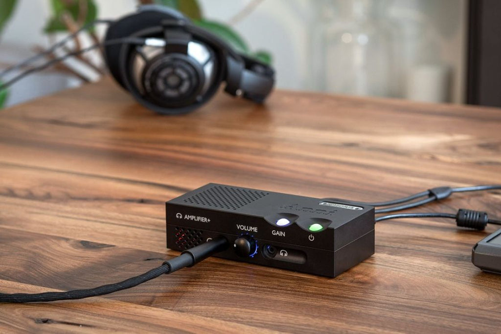 Chord Electronics Anni stereo amplifier showing a sleek black design with control knobs and input ports on the front panel.