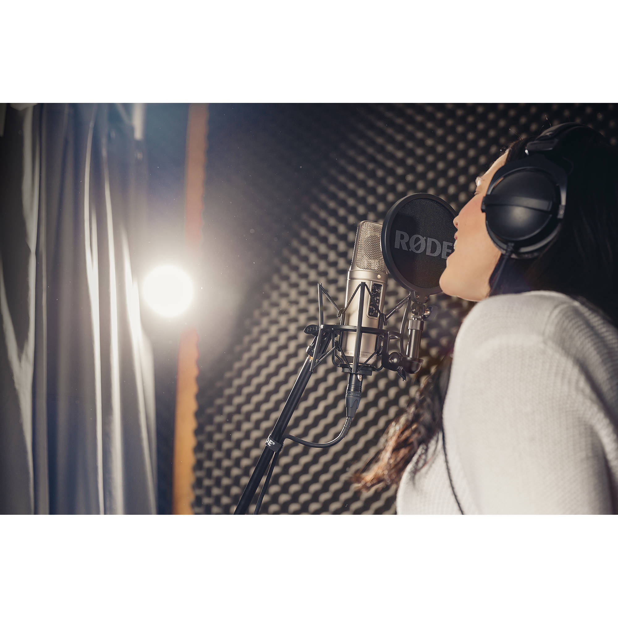 Rode NT2-A condenser microphone with shock mount and accessories in a studio setup for professional audio recording.