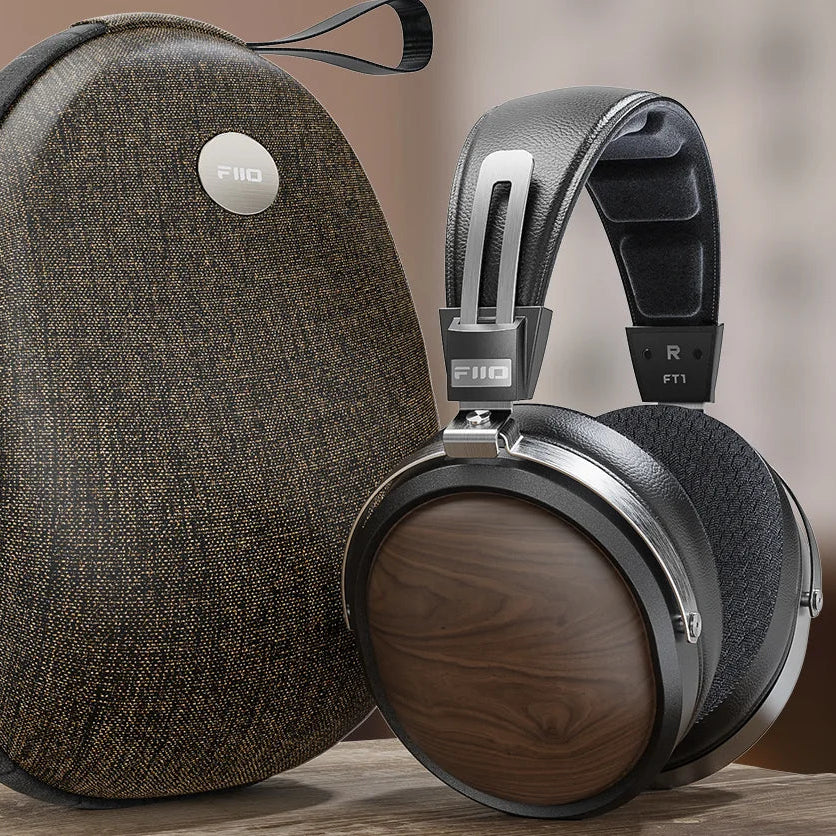 FiiO FT1 wired headphones with black earbuds and inline remote, designed for high-quality audio and comfortable listening.