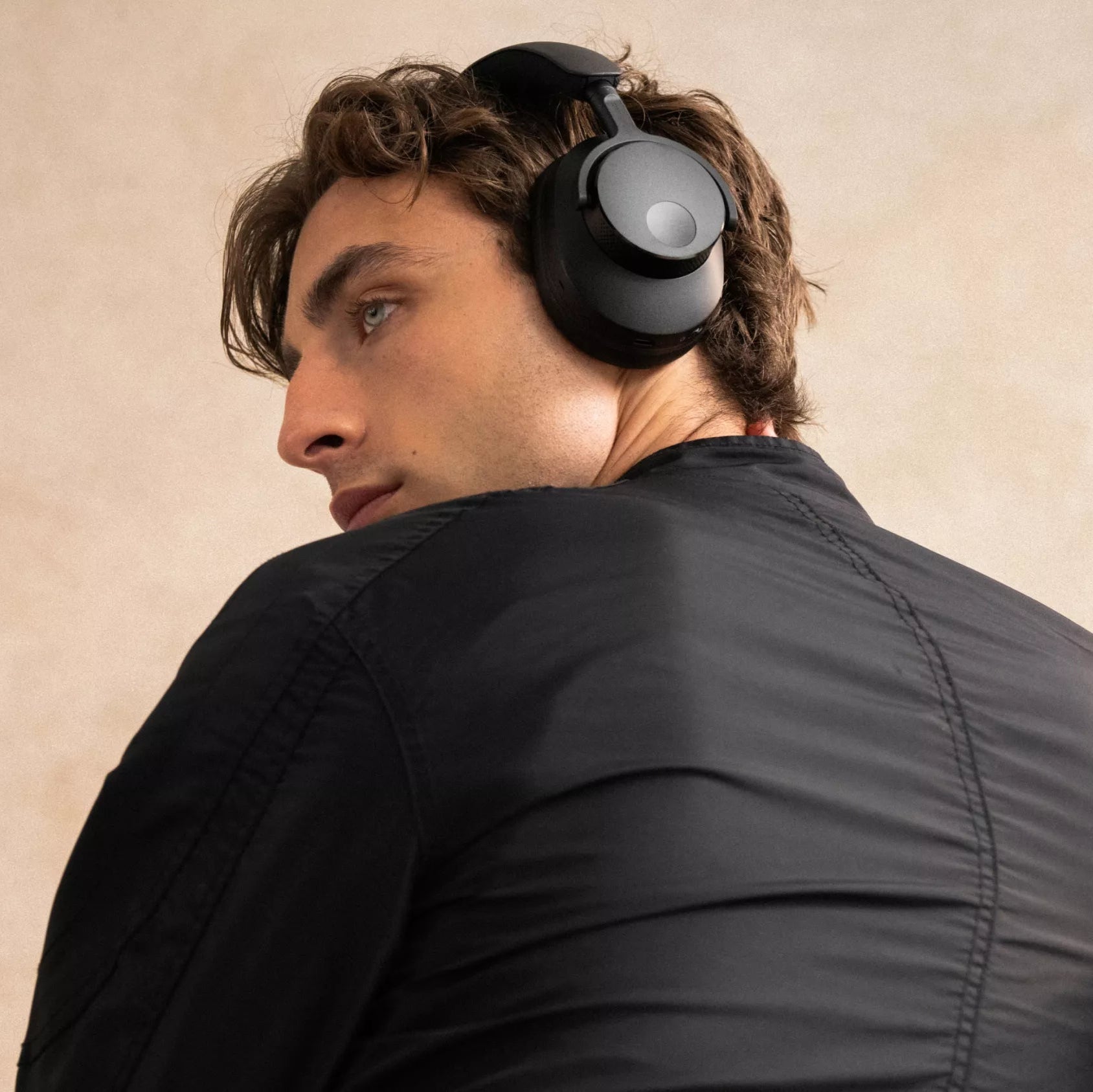 Cambridge Audio Melomania P100 SE wireless headphones with sleek black design and in-ear earbuds, showcasing their compact style.
