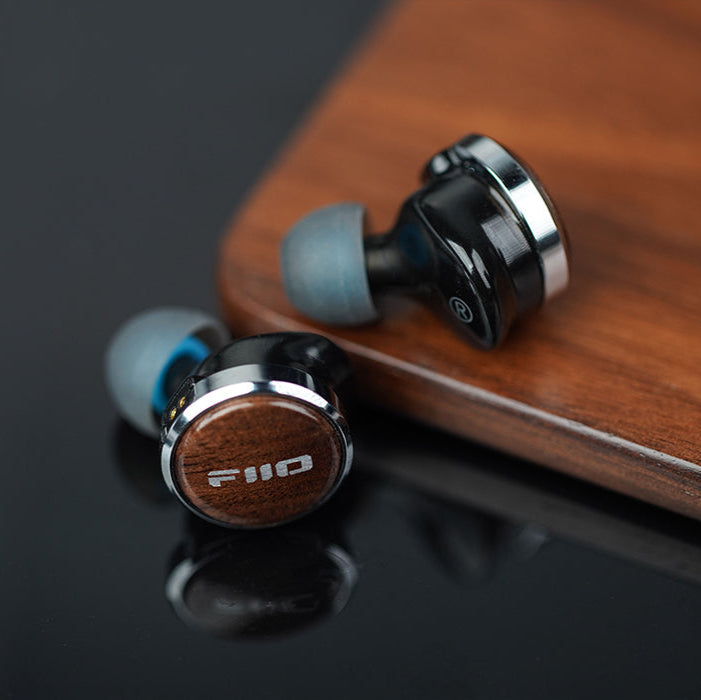 FiiO FP3 in-ear headphones with black earbuds and inline remote, designed for high-quality audio and comfortable fit.