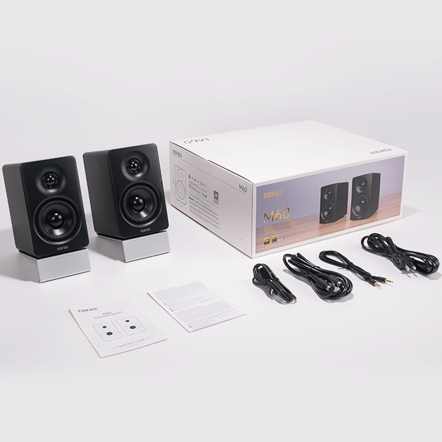 Edifier M60 desktop speakers with sleek black design, compact size, and connected audio jacks visible on the front.