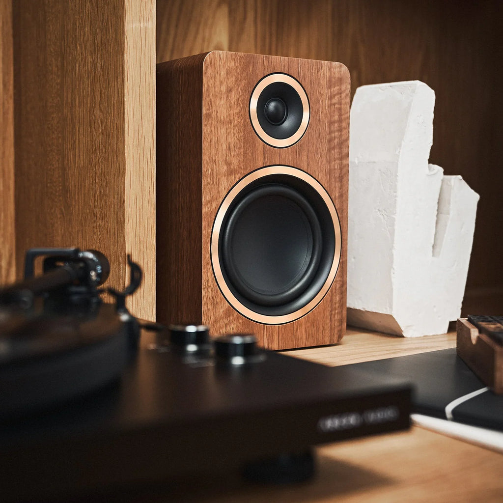 Argon Audio Fenris A5 active bookshelf speakers in white with wood finish, showcasing their sleek design and driver components.