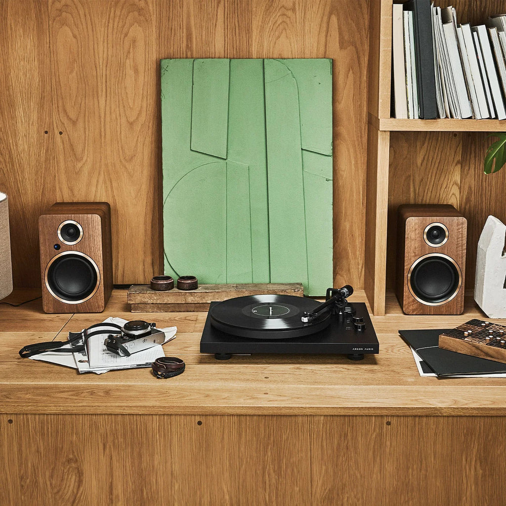 Argon Audio Fenris A5 active bookshelf speakers in black with wooden finish, showing front view with speaker grille and branding