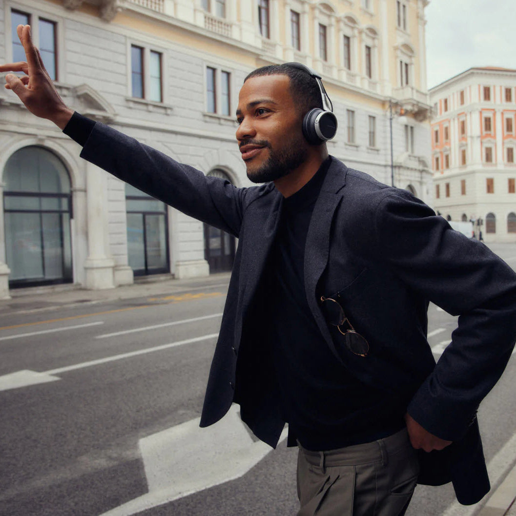 Black Beyerdynamic Aventho 100 wireless headphones shown in a lifestyle setting, featuring sleek over-ear design and comfortable fit.