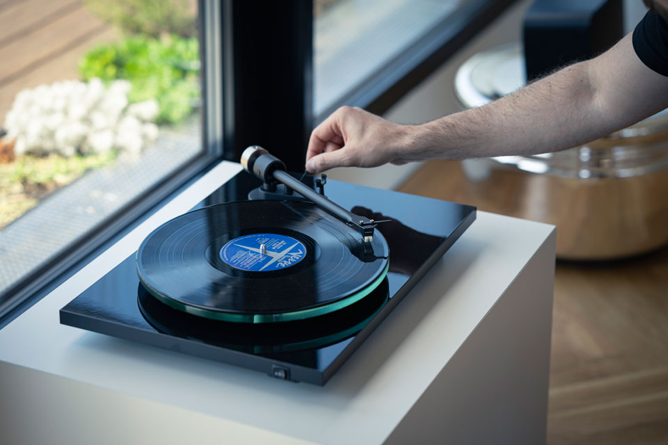 Pro-Ject T2 Super Phono turntable with sleek design and tonearm, featuring high-quality audio components for premium vinyl listening.