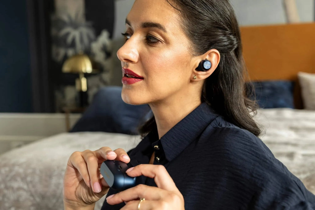 Wireless in-ear headphones by Technics, AZ100 model, shown in a lifestyle setting with sleek earbud design and compact charging case.