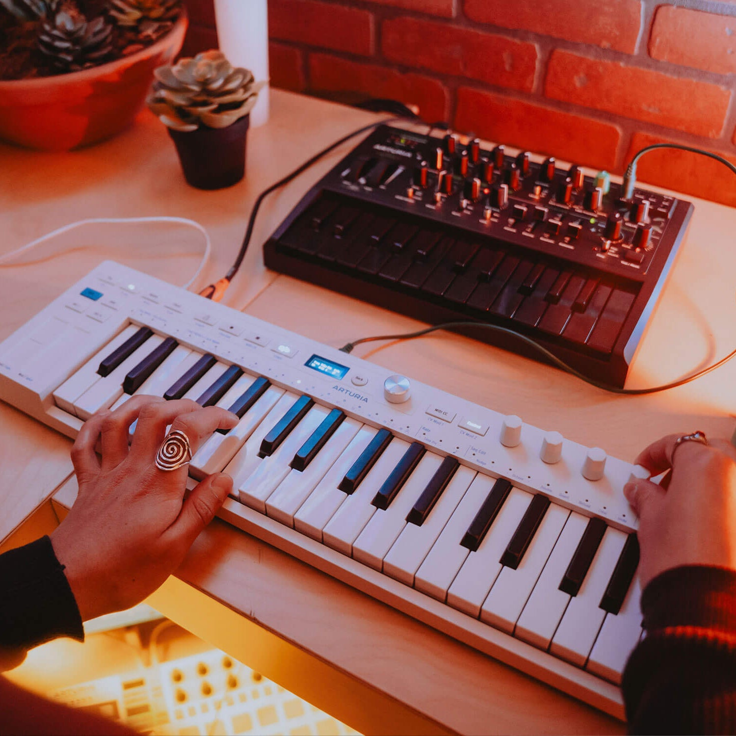 Arturia KeyStep 37 MK2 MIDI sequencer with keyboard, showing control knobs, pads, and pitch/mod wheels on a sleek black design.