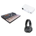 Arturia MicroFreak keyboard bundle with accessories for home studio setup, featuring compact digital synthesizer and musical production tools.