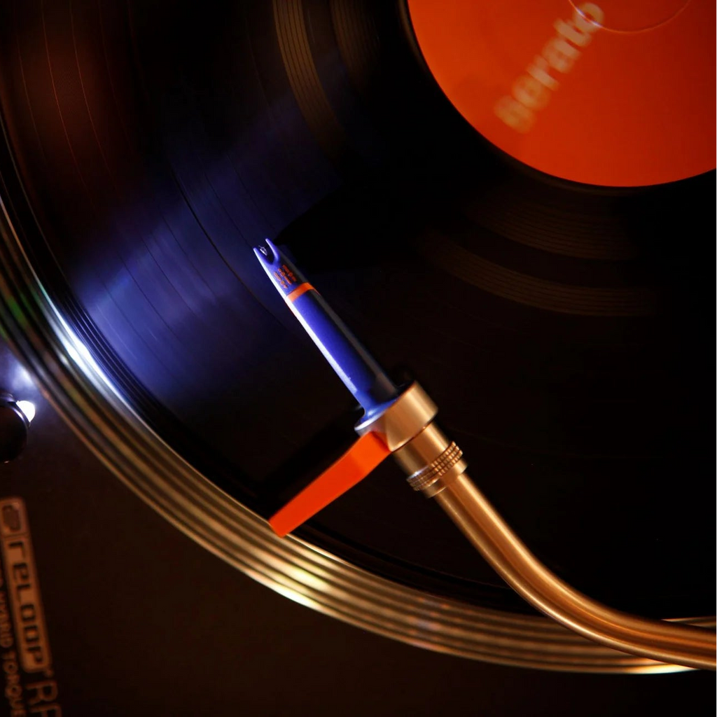 Ortofon Concorde DJ MK2 turntable cartridge with stylus, shown from a top view on a turntable cartridge holder.