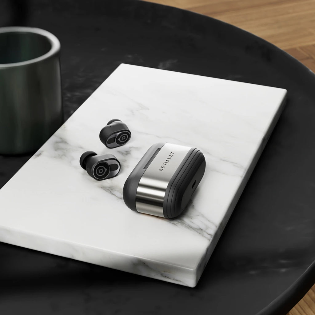 Devialet Gemini II wireless in-ear headphones shown in dark color with sleek design and compact charging case.